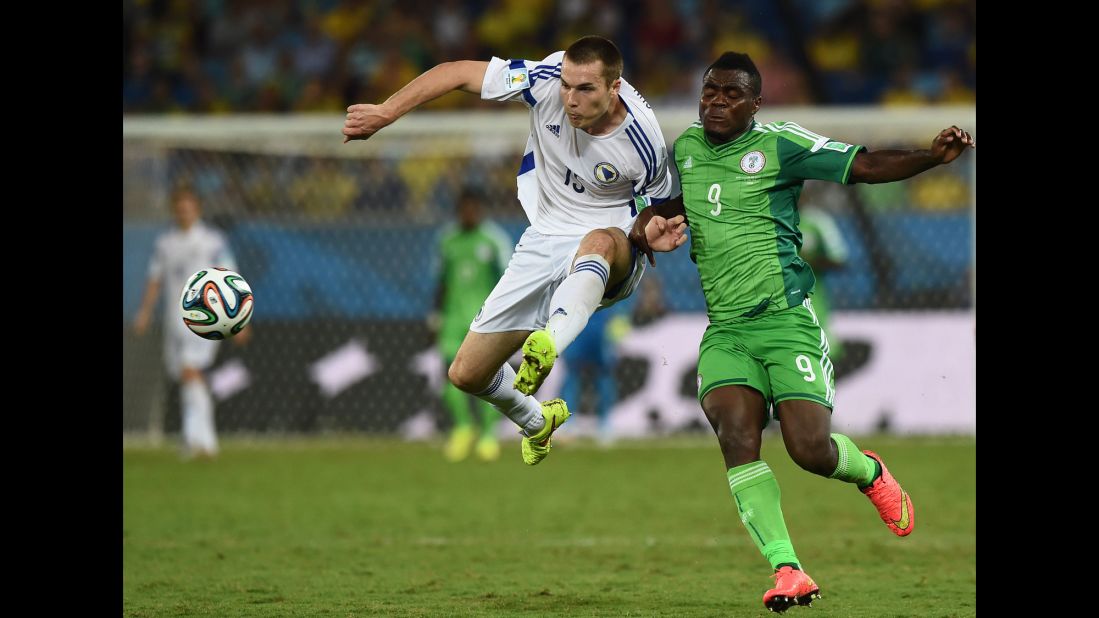 Nigeria forward Emmanuel Emenike, right, challenges Bosnia-Herzegovina defender Toni Sunjic.