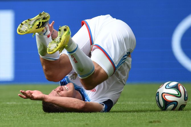 Russia's forward Maxim Kanunnikov tumbles.