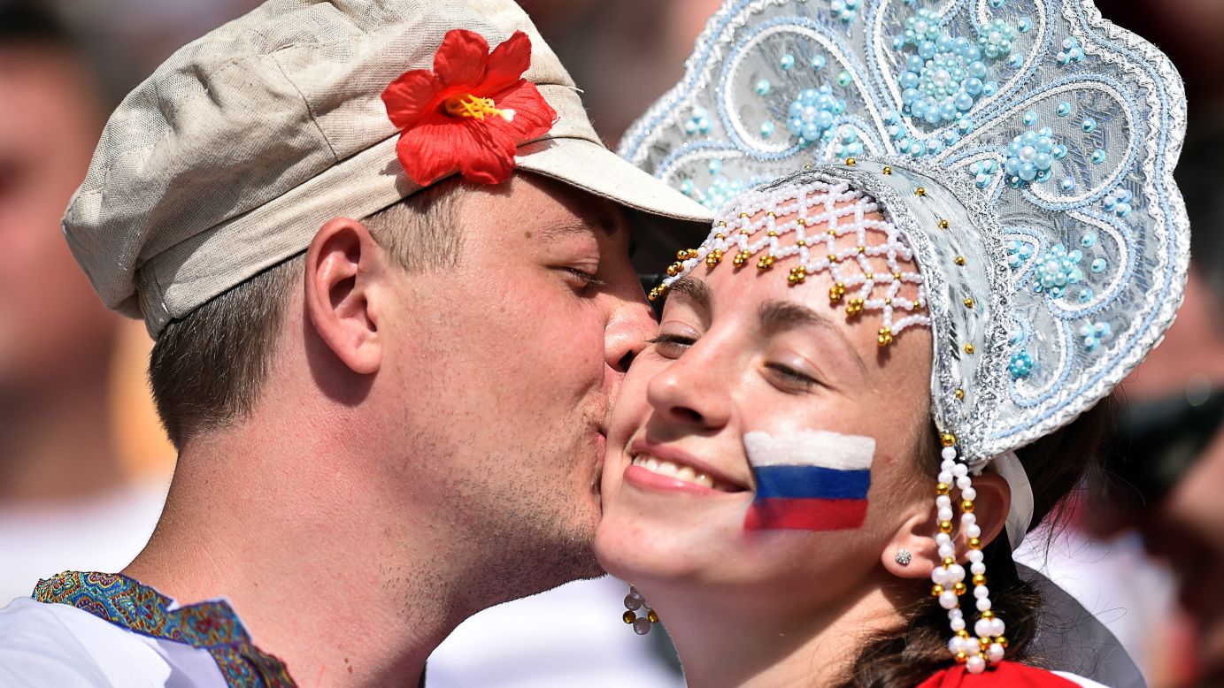 Russia supporters kiss during the game.
