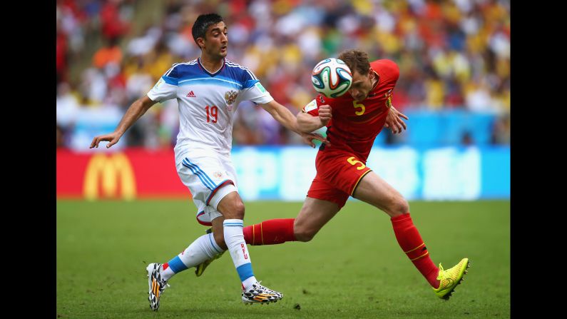 Jan Vertonghen of Belgium and Alexander Samedov of Russia compete for the ball. <a href="index.php?page=&url=http%3A%2F%2Fwww.cnn.com%2F2014%2F06%2F21%2Ffootball%2Fgallery%2Fworld-cup-0621%2Findex.html">See the best World Cup photos from June 21.</a>