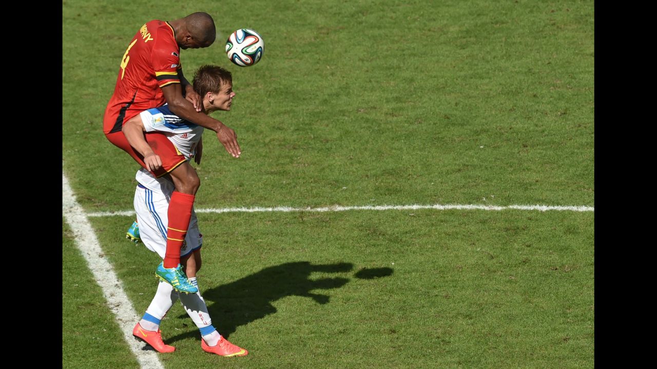 Belgian defender Vincent Kompany heads the ball past Russia's forward Alexander Kokorin.