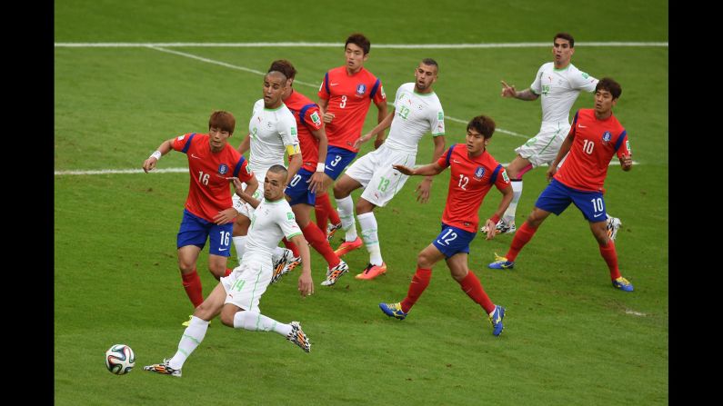 Algerian midfielder Nabil Bentaleb, second left, competes for the ball with South Korean midfielder Ki Sung-yueng, first left, on June 22.