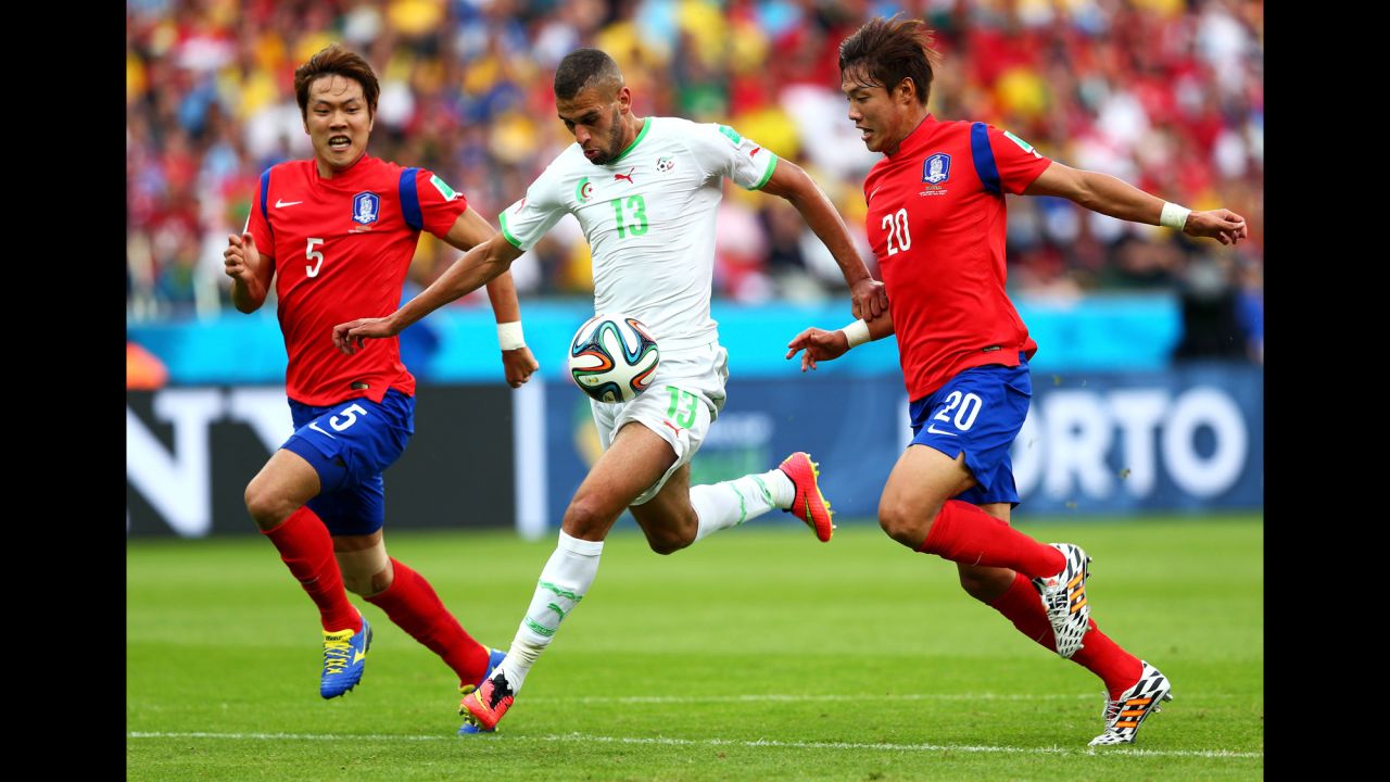 Islam Slimani of Algeria breaks through South Korean defenses on his way to scoring his team's first goal.