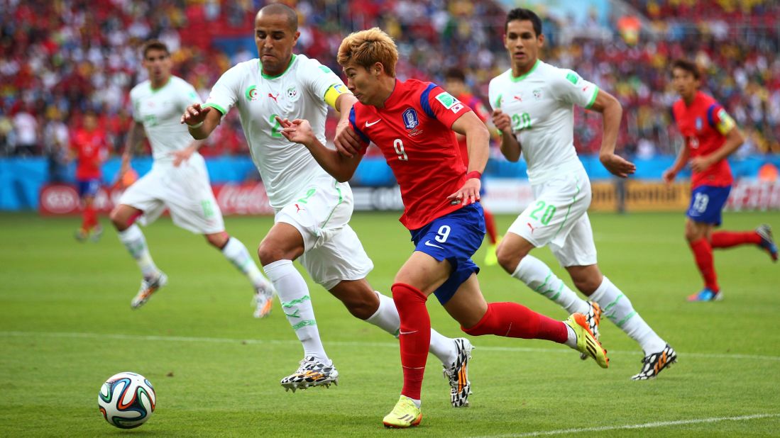 Son Heung-min of South Korea controls the ball against Madjid Bougherra of Algeria.