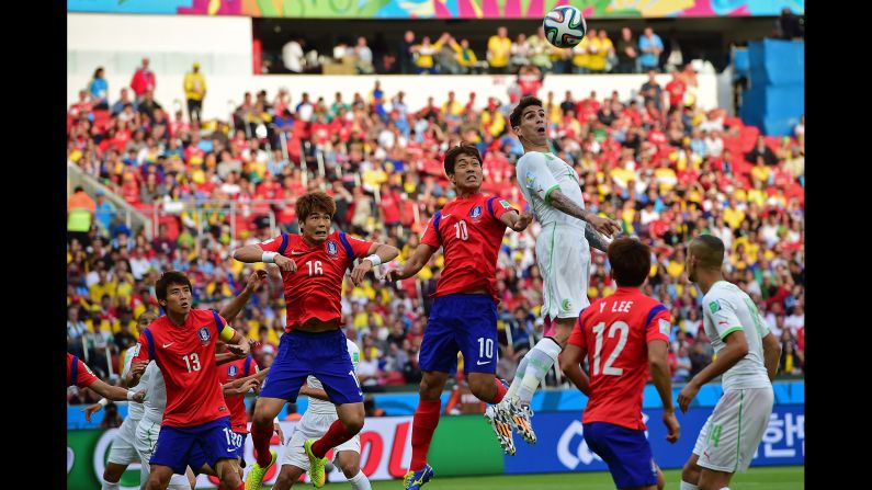 Algerian defender Carl Medjani jumps to head the ball.