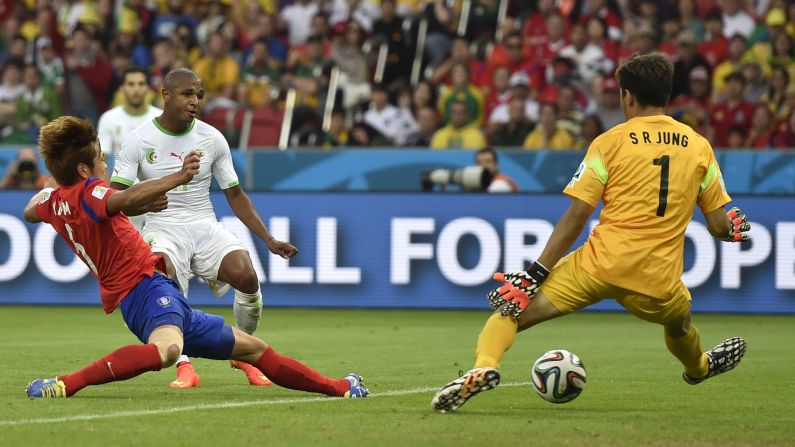 Yacine Brahimi, second left, scores Algeria's fourth goal against South Korea.