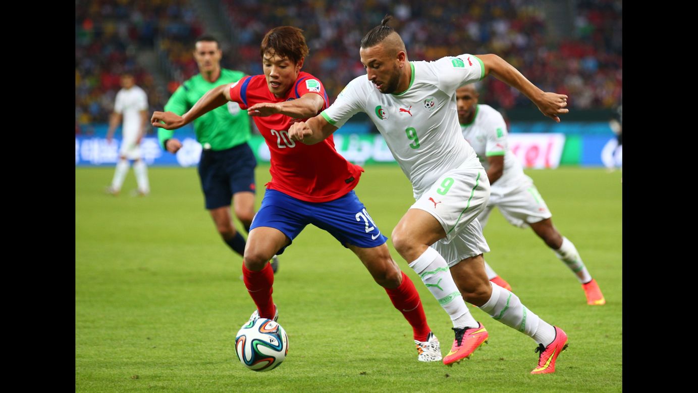 Hong Jeong-ho of South Korea and Nabil Ghilas of Algeria compete for the ball.