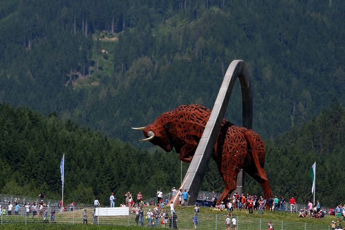 Fans walk around a giant Red Bull sculpture before the race at the revamped Red Bull Ring in the town of Spielberg. The grand prix was the first to be held in Austria in 11 years.