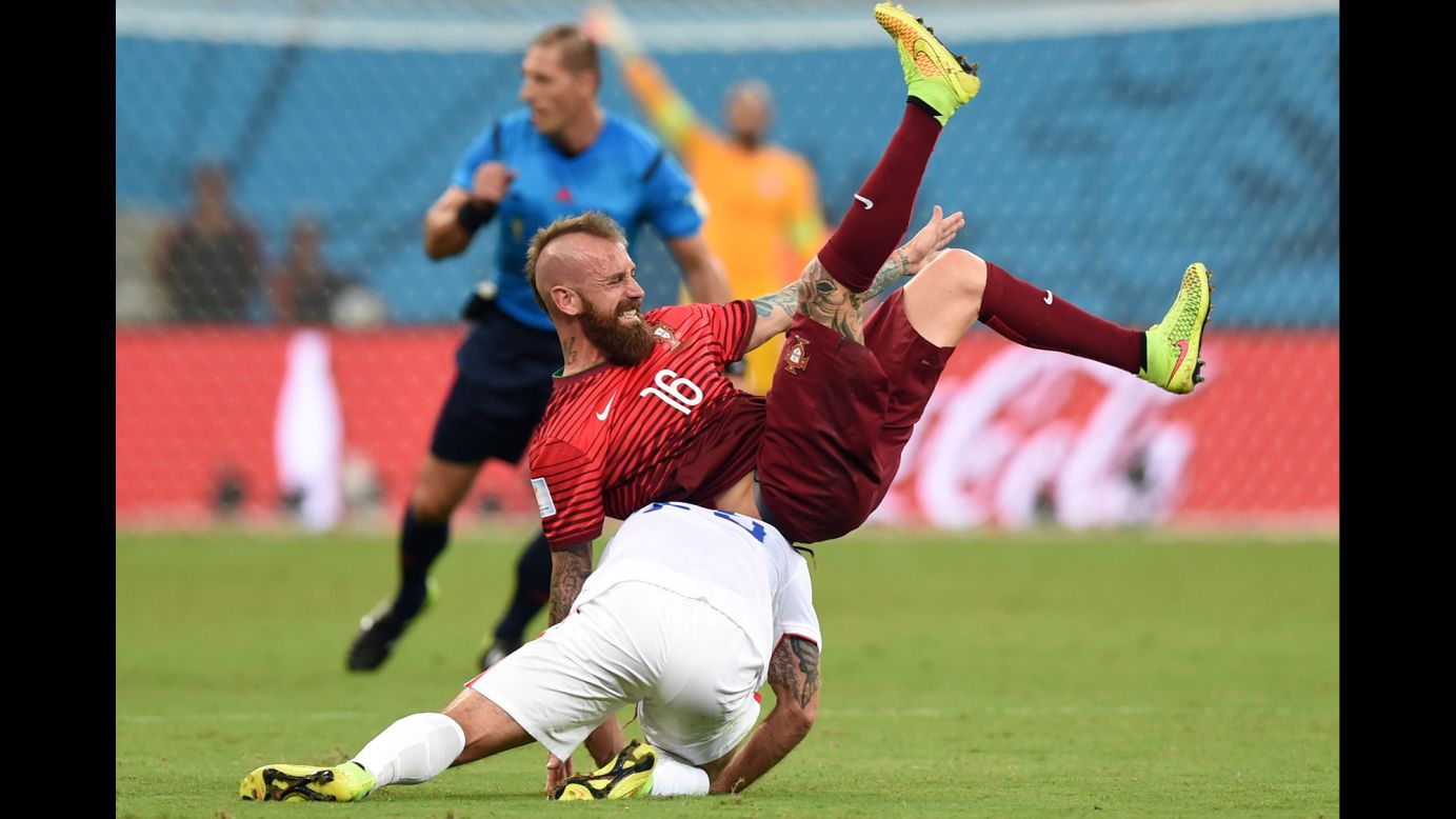 Portugal midfielder Raul Meireles and U.S. midfielder Kyle Beckerman tumble during the June 22 match in Manaus, Brazil.