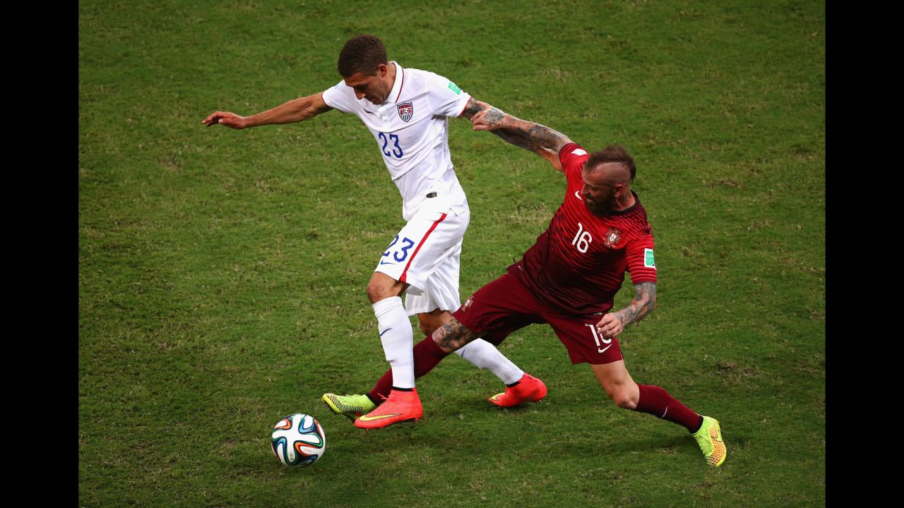 Fabian Johnson of the United States battles Raul Meireles of Portugal.