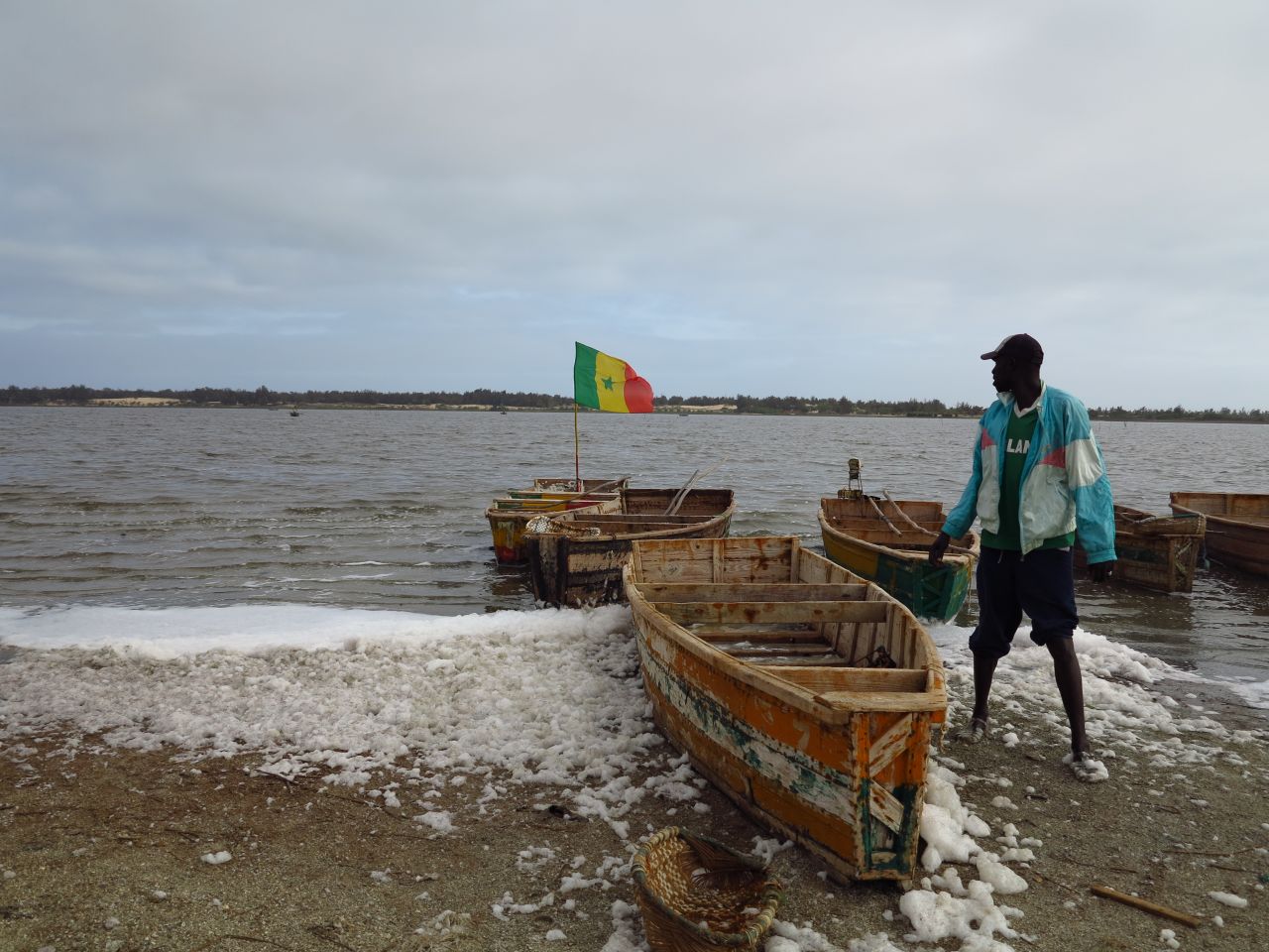 Senegalese men such as 24-year-old Moussa Fame collect salt from the lake to earn a living. 