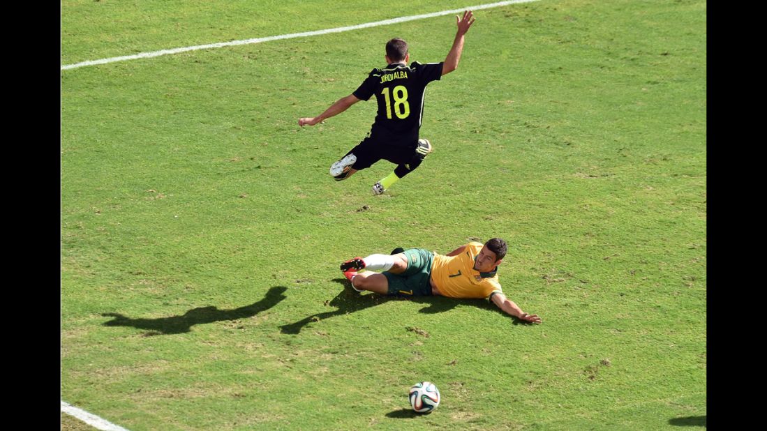 Spain defender Jordi Alba, top, vies with Australia forward Mathew Leckie.