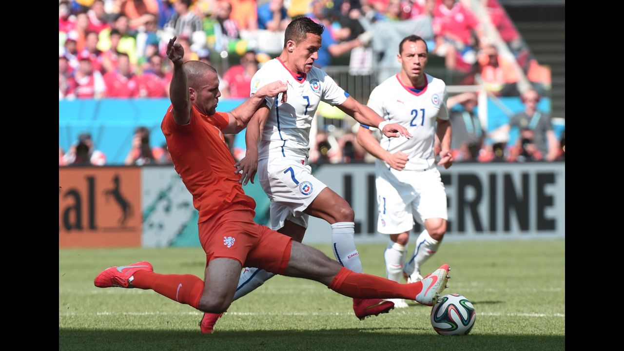 Netherlands defender Ron Vlaar, left, and Chile forward Alexis Sanchez compete for the ball.