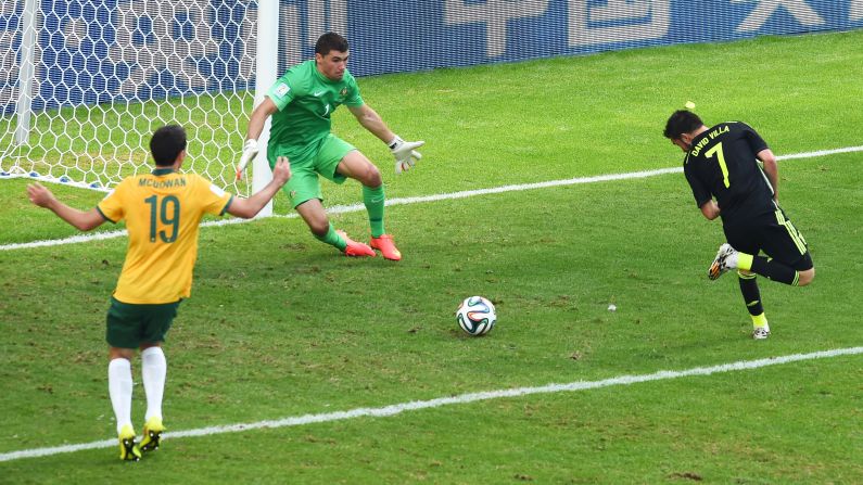 David Villa of Spain scores his team's first goal past Mathew Ryan of Australia.