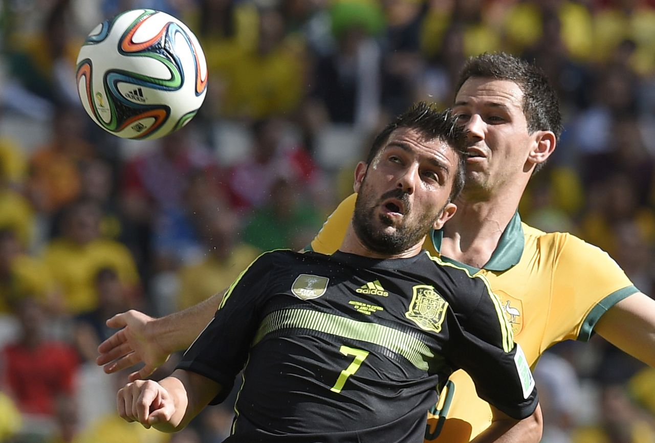 Spain forward David Villa, front, in action against Australia defender Ryan McGowan.