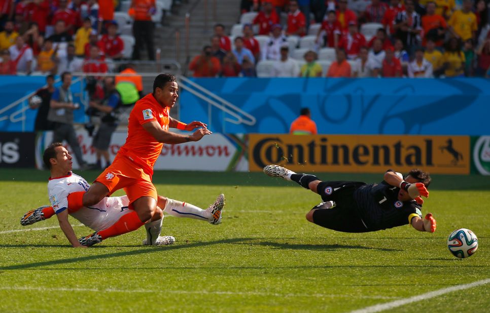 Memphis Depay of the Netherlands scores his team's second goal past Chile's goalkeeper Claudio Bravo in Sao Paulo on June 23. Netherlands won 2-0.