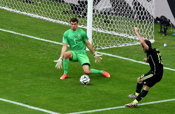 Juan Mata scores the third goal for Spain past Mathew Ryan of Australia at Arena da Baixada in Curitiba, Brazil, on June 23. Spain defeated Australia 3-0, but neither team will advance to the next round.