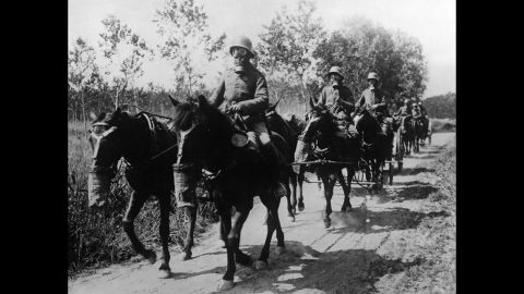 A German cavalry unit with both horses and soldiers wearing gas masks advances during the Second Battle of the Aisne at Soissons, France, in June 1918.