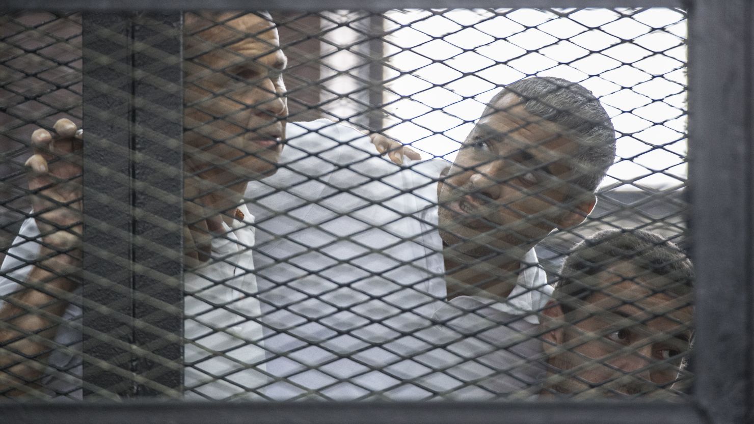 Journalists Peter Greste, left, Mohamed Fadel Fahmy, center, and Baher Mohamed on June 23, 2014 during their Cairo trial.