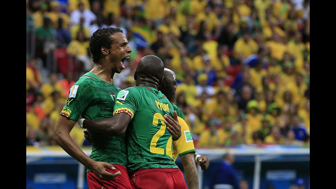 Cameroon midfielder Joel Matip, left, celebrates with his teammates after scoring a goal against Brazil.