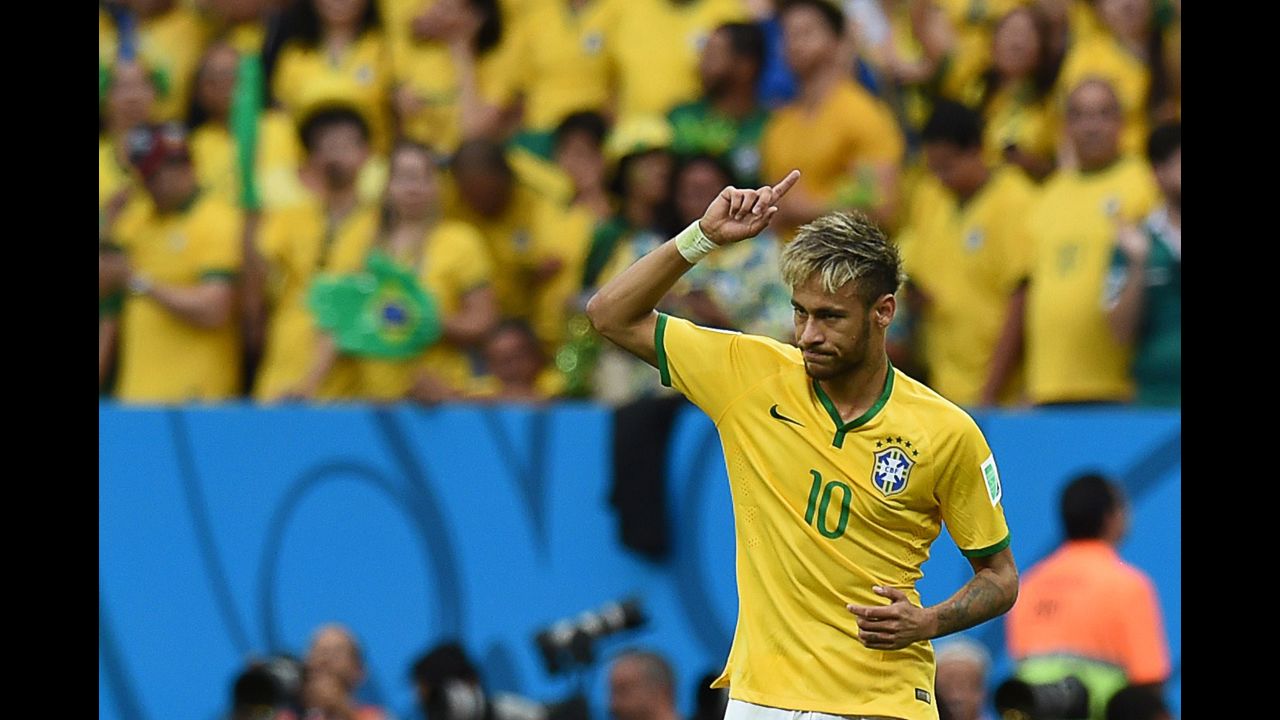 Neymar celebrates after scoring a goal against Cameroon.
