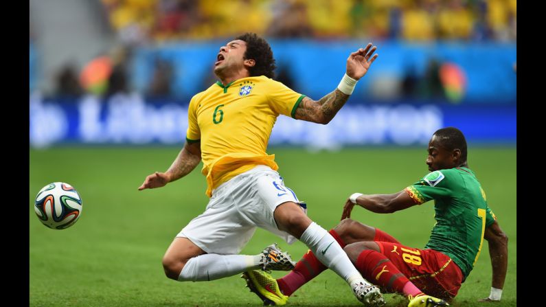 Brazil's Marcelo, left, is challenged by Enoh Eyong of Cameroon.