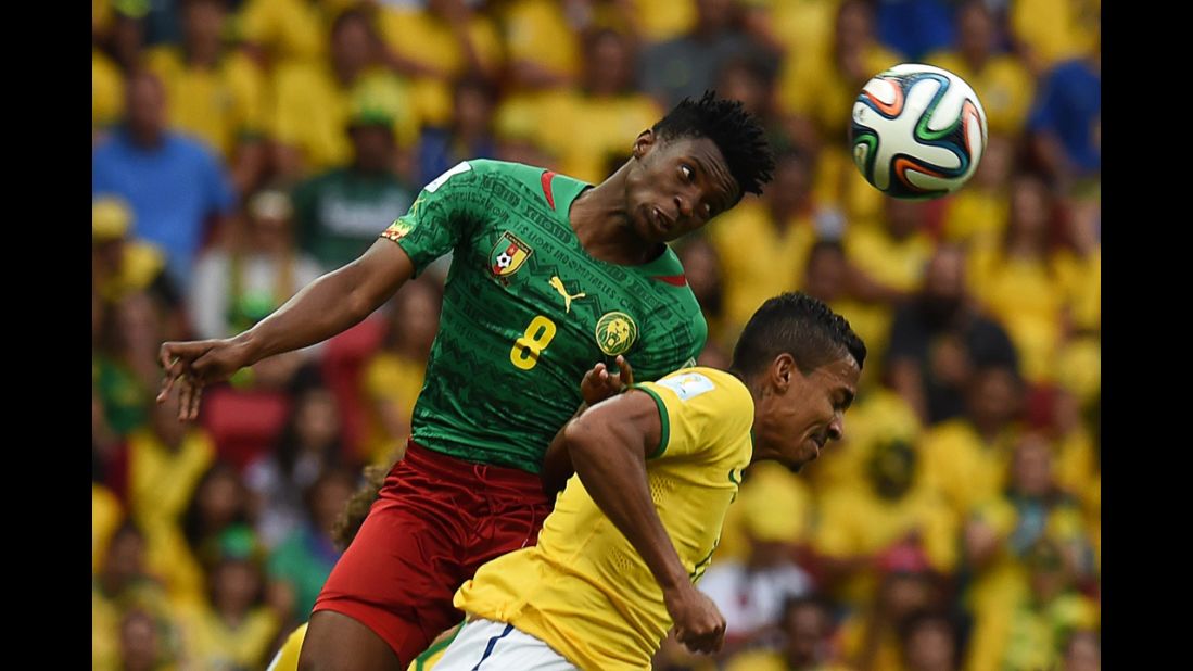 Cameroon forward Benjamin Moukandjo, left, and Brazil midfielder Luiz Gustavo vie for the ball.