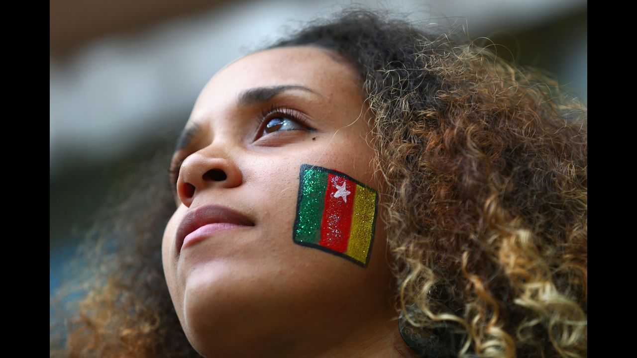 A fan sports a Cameroon flag painted on her face during the match against Brazil.