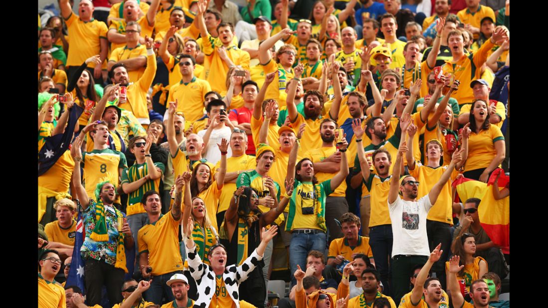 Australian fans cheer during the match against Spain at Arena da Baixada.
