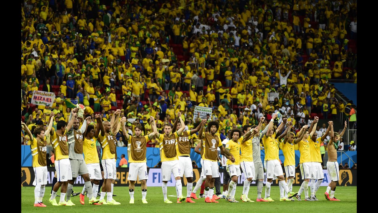 Brazilian players celebrate as they leave the pitch at the end of the match against Cameroon. Brazil won 4-1.