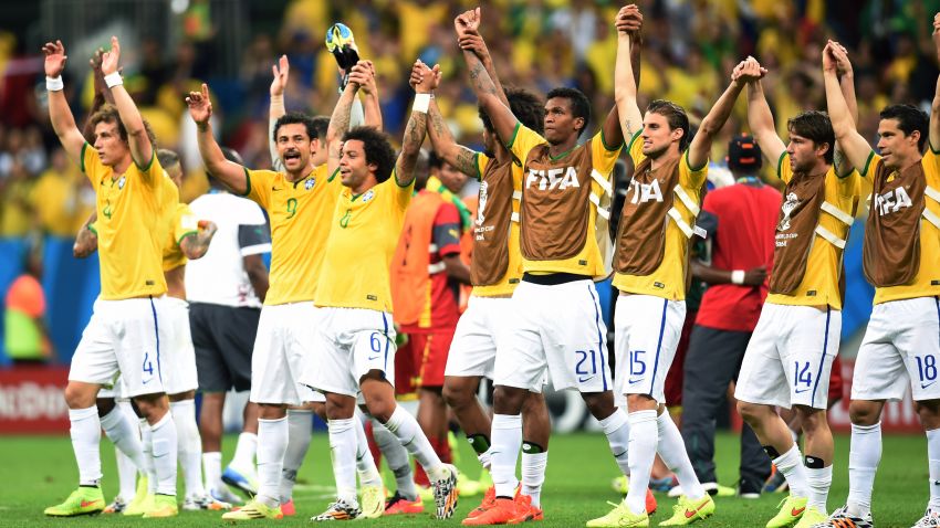 Brazil's players celebrate at the end of a Group A football match between Cameroon and Brazil at the Mane Garrincha National Stadium in Brasilia during the 2014 FIFA World Cup on June 23, 2014. AFP PHOTO / PEDRO UGARTE (Photo credit should read PEDRO UGARTE/AFP/Getty Images)