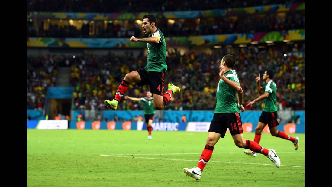 Rafael Marquez, left, of Mexico celebrates scoring his team's first goal with teammate Javier Hernandez.
