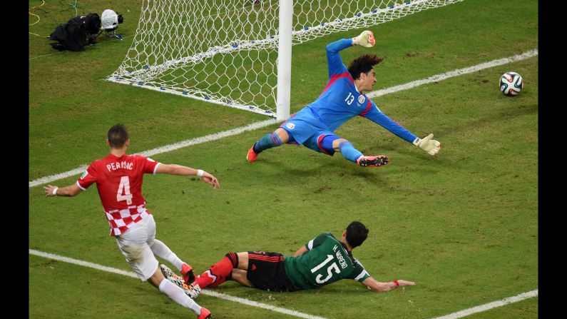 Goalkeeper Guillermo Ochoa of Mexico fails to stop Croatian midfielder Ivan Perisic from scoring on Monday, June 23, in Recife, Brazil. Mexico won 3-1.