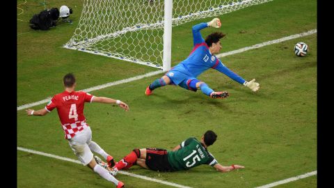 Goalkeeper Guillermo Ochoa of Mexico fails to stop Croatian midfielder Ivan Perisic from scoring on Monday, June 23, in Recife, Brazil. Mexico won 3-1. 