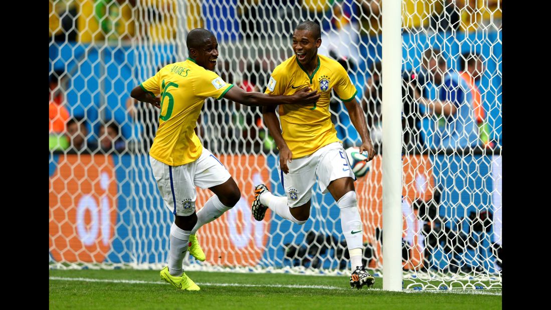 Fernandinho of Brazil, right, celebrates with his teammate Ramires after scoring his team's fourth and final goal against Cameroon on June 23 in Brasilia. Brazil won 4-1.