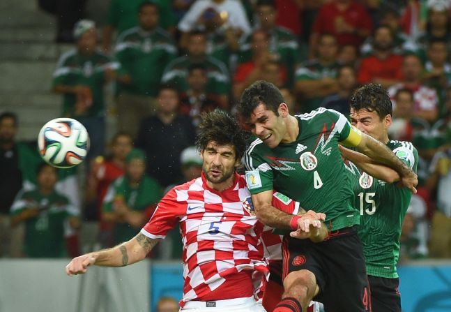 Mexico's Rafael Marquez, center, heads the ball to score his team's first goal against Croatia.