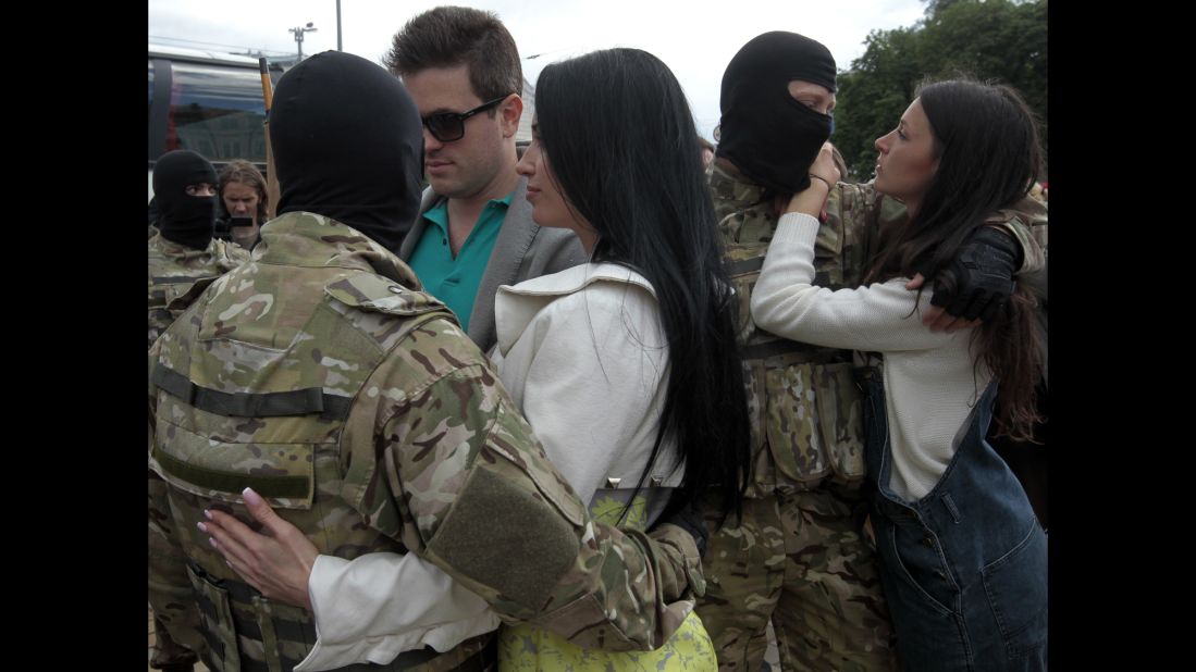 People say goodbye to volunteer soldiers in Kiev, Ukraine, before they leave for the eastern part of the country to join the ranks of a special battalion on Monday, June 23. 