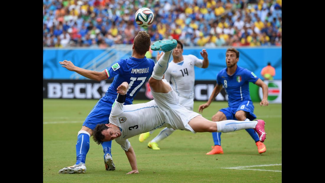 Diego Godin of Uruguay and Ciro Immobile of Italy compete for the ball. 
