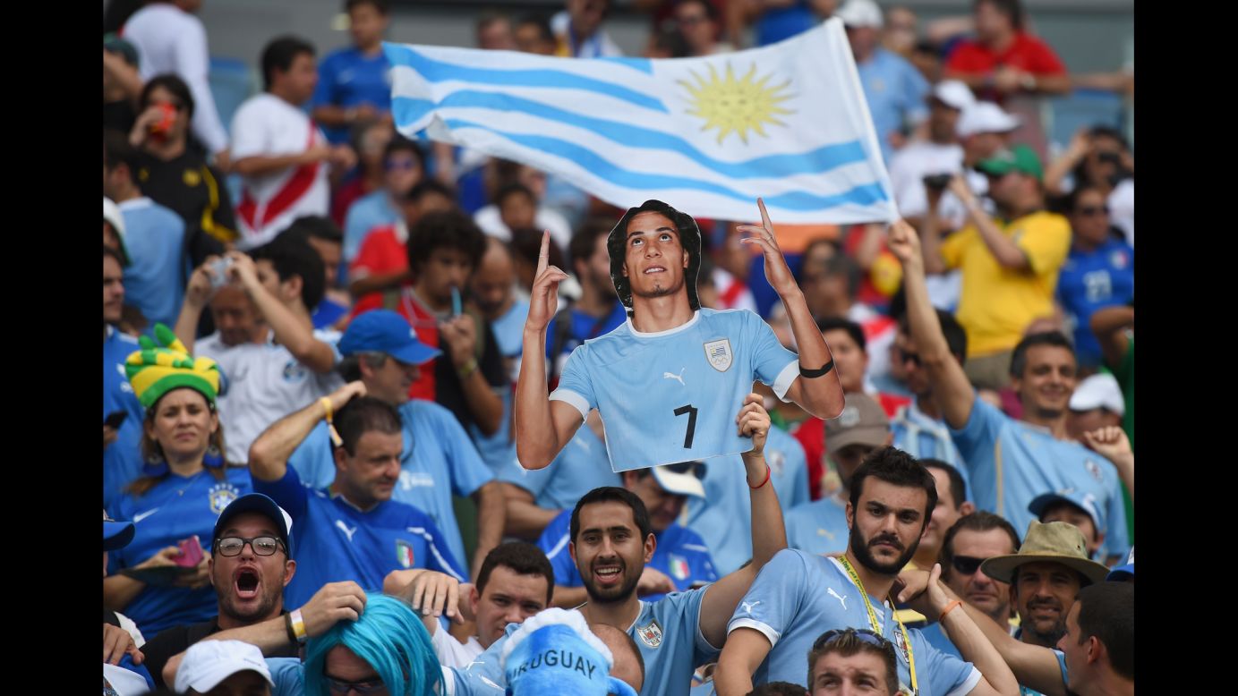A Uruguay fan holds a cutout of Cristian Rodriguez ahead of the match against Italy.