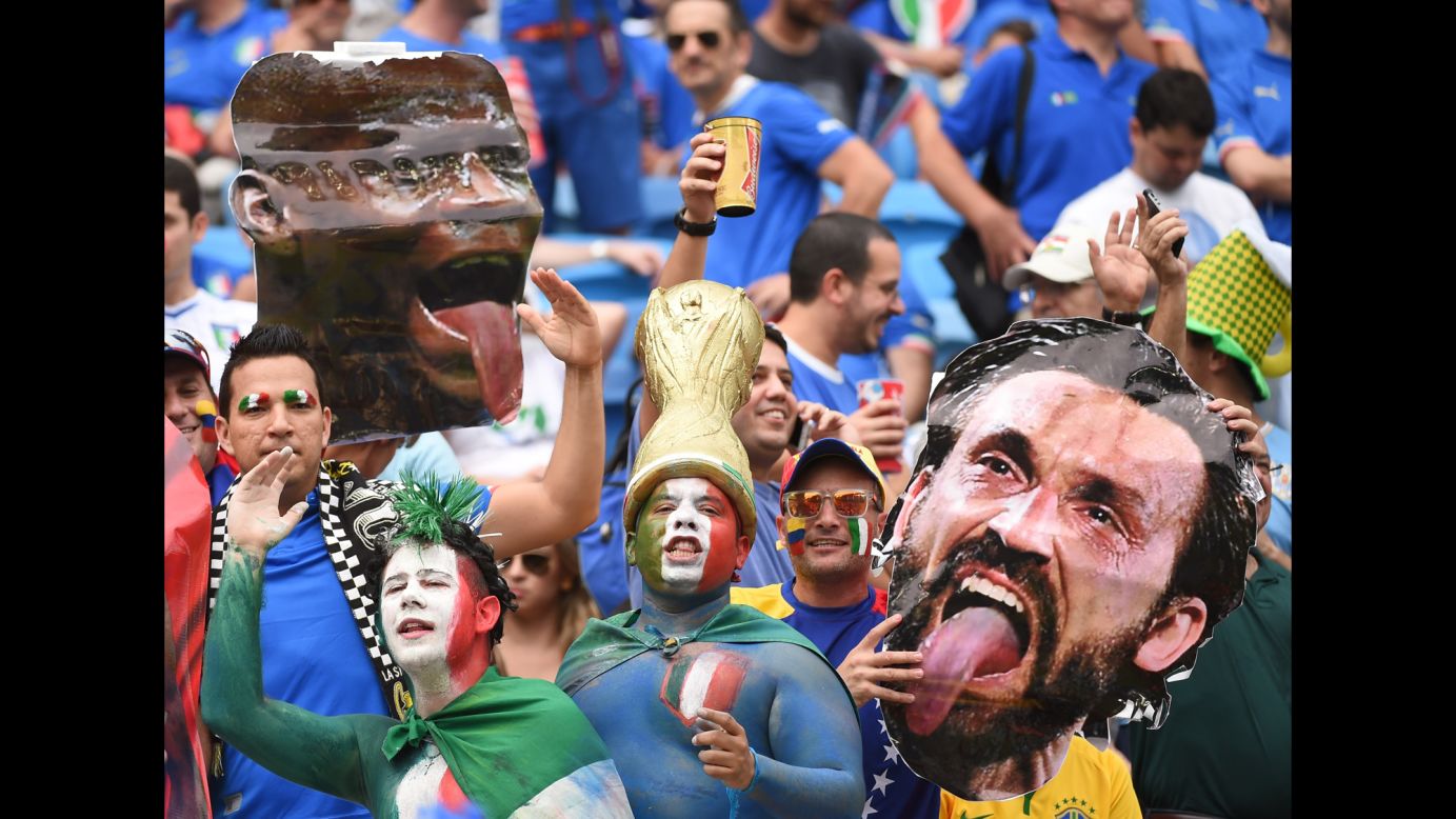 Italy fans hold up cardboard cutouts of forward Mario Balotelli, left, and midfielder Andrea Pirlo. 