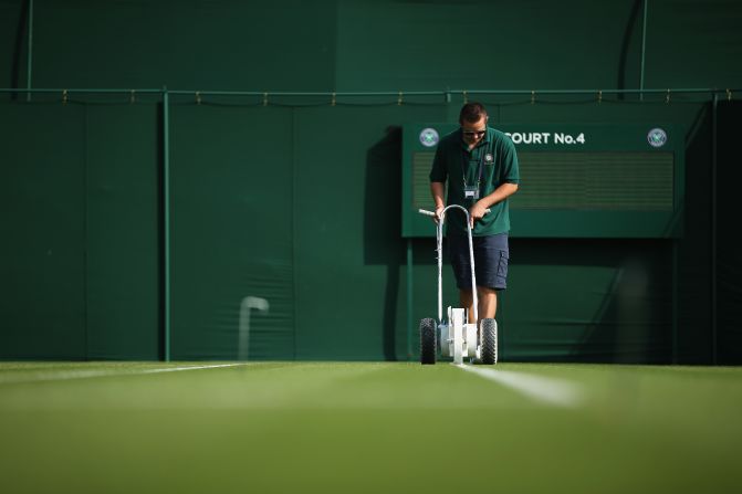 The grass courts are prepared prior to the matches on day two of the championships.