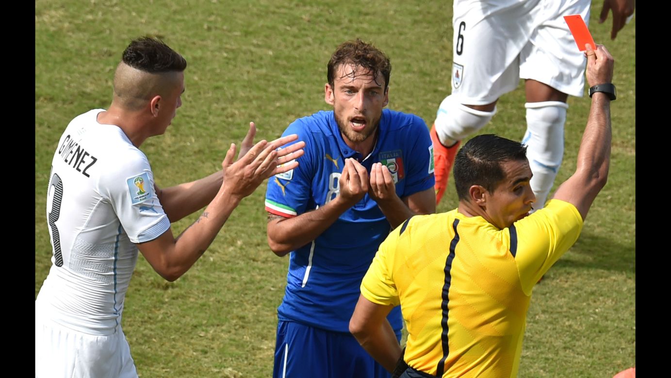 Italy midfielder Claudio Marchisio, center, reacts as he is shown a red card by referee Marco Antonio Rodriguez Moreno. 