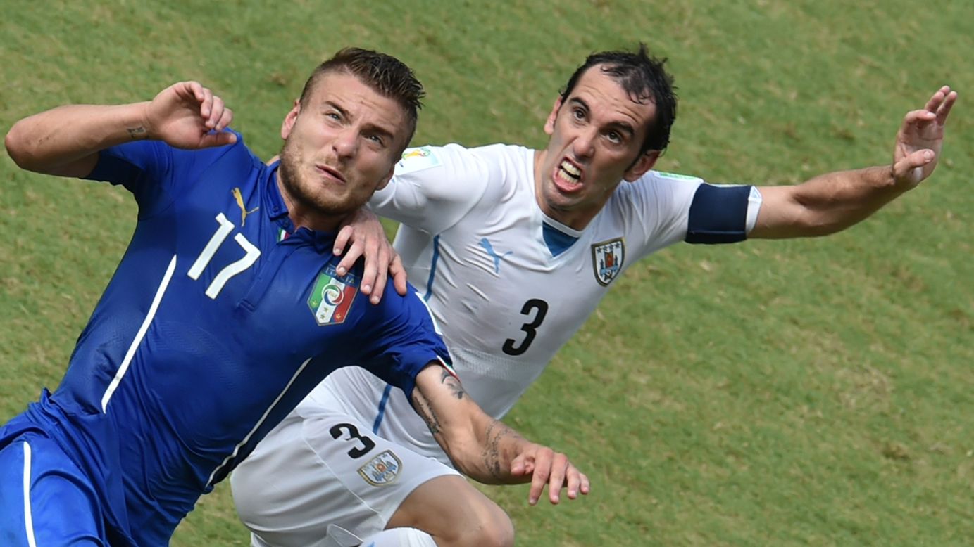 Italy forward Ciro Immobile, left, vies with Uruguay defender Diego Godin. 