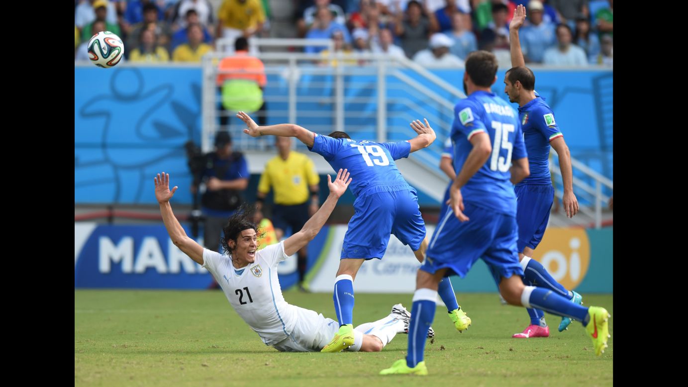 Uruguay's Edinson Cavani, left, is fouled by Italy's Leonardo Bonucci in the penalty area. 