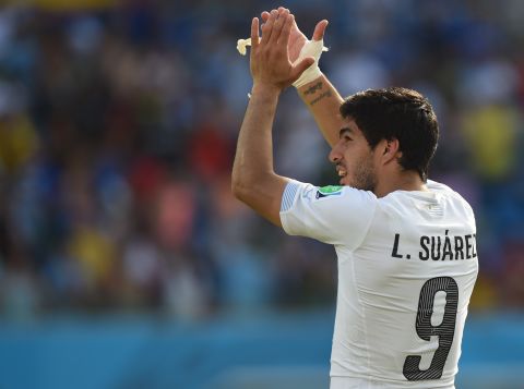 Suarez celebrates as Uruguay booked their place in the last 16 thanks to a 1-0 win, secured by Diego Godin's header.