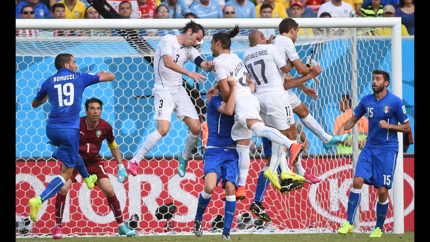 Uruguay defender Diego Godin, third left, scores. 