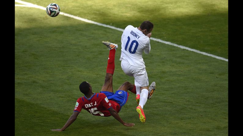 England forward Wayne Rooney, right, reacts after a challenge from Costa Rica defender Junior Diaz. 