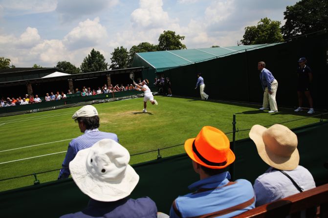 Spectators enjoying the sunshine on one of the All England Club's outer courts.