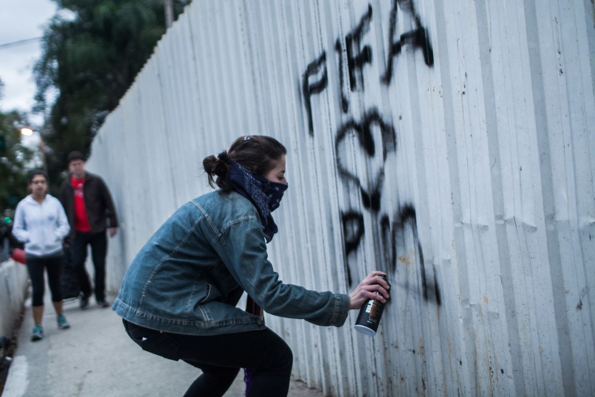 Anger around the hosting of the World Cup, however, has pushed an increasing number of artists and protesters to "try to do something with ... a more critical view," said Paulo Ito.<br />Here, a member of the MPL 'Free Pass Movement' sprays graffiti during a protest for free transportation.