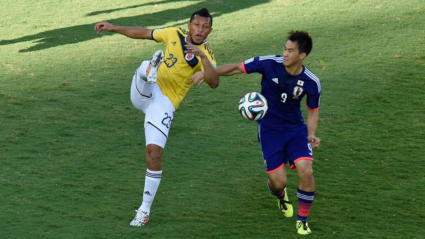 Colombia's Carlos Valdes, left, vies for the ball with Japan's Shinji Okazaki during a World Cup match in Cuiaba, Brazil.